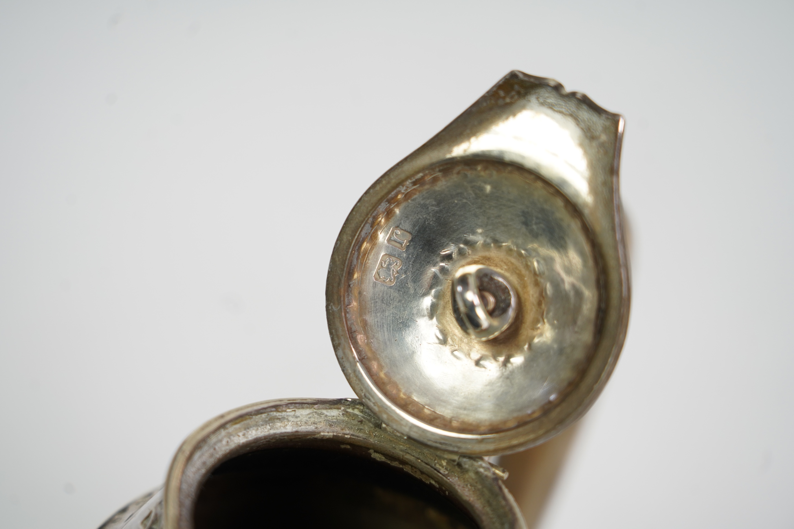 A George V Arts & Crafts silver hot water pot by Liberty & Co
